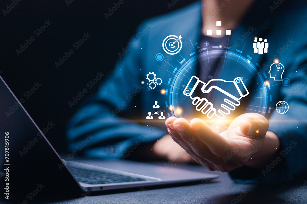 Ταπετσαρία Businessmen use laptop with virtual handshake icon for business joint venture concept, data exchange customer connection, teamwork and successful business