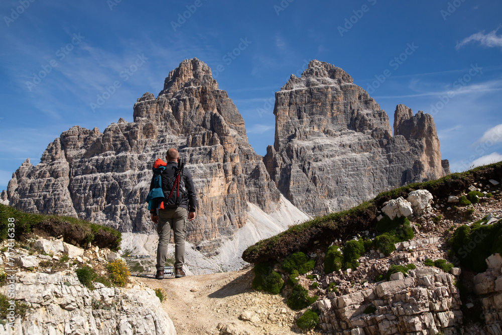 Stunning view of a tourist enjoying the view of the Tre Cime Di Lavaredo, Dolomites, Italy. Stunning view of a tourist enjoying the view of the Tre Cime Di Lavaredo, Dolomites, Italy.