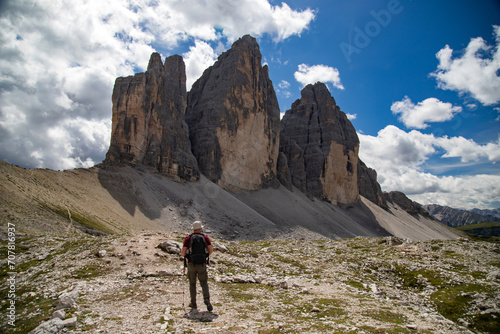 Stunning view of a tourist enjoying the view of the Tre Cime Di Lavaredo, Dolomites, Italy. © erika8213