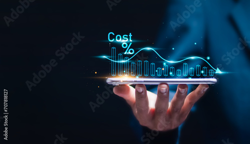 Cost reduction business finance concept. Businessman with virtual screen of Cost reduction graph with down arrow for budget management and cost management. photo