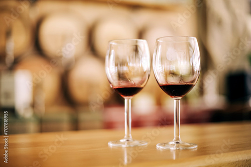 Two glasses of red wine on wooden table