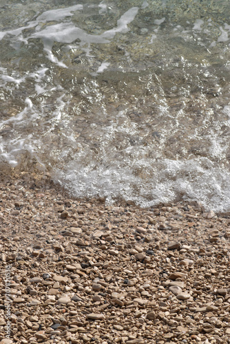 Pebble Shoreline with Crashing Waves and Clear Water