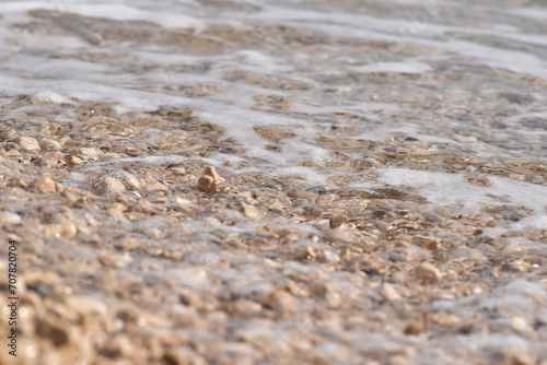 Pebble Shoreline with Crashing Waves and Clear Water