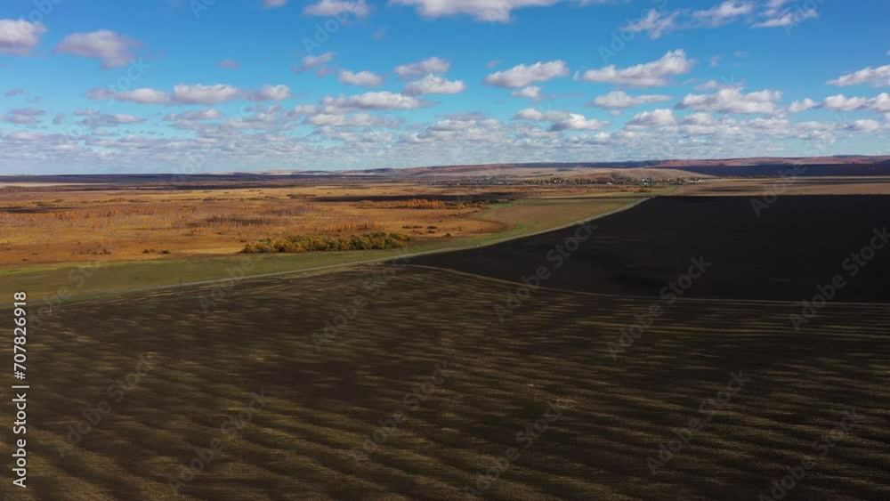 Beautiful panoramic view of plowed fields after harvesting in autumn, drone view Beautiful panoramic view of plowed fields after harvesting in autumn, drone view