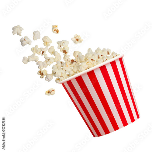 Tasty popcorn falling out of a red striped carton bucket on transparent background png © Nofi