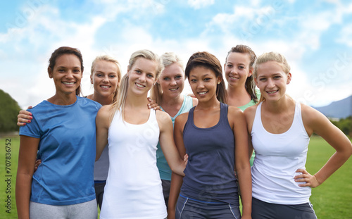 Group, friends and smile on field with portrait for fitness, sport and exercise with collaboration. Teamwork, people and women with face, health or blue sky outdoor in nature for workout or training