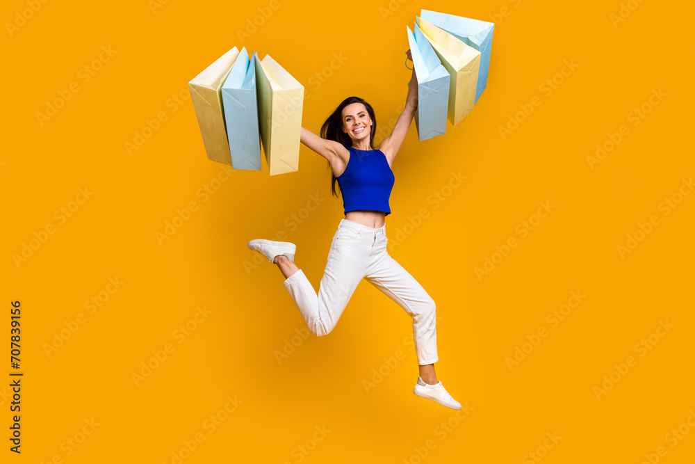 Φωτογραφία Full length photo of pretty cheerful lady dressed blue top rising shoppers isola