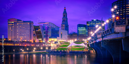 Hartford Twilight Skyline over the Connecticut River, a vibrant cityscape of skyscrapers, Riverfront Plaza, and Founders Bridge in the Capital City of Connecticut State, United States photo