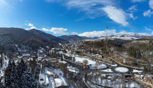 Mountain region. Nature Armenia. Landscape mountain city. Outskirts Delizhan on winter day. Buildings at foot of mountains. Landscape of small town as seen from quadcopter. Traveling around Armenia