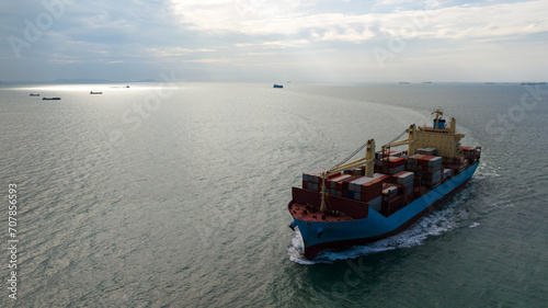 logistic cargo container ship sailing in sea to import export goods and distributing products to dealer and consumers across worldwide, aerial front view © SHUTTER DIN