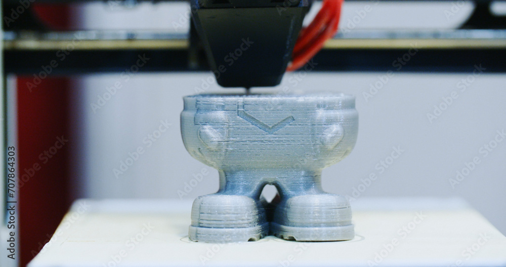 Closeup shot of a 3D printer in the process of printing a polymer element Closeup shot of a 3D printer in the process of printing a polymer element