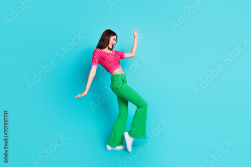 Full length photo of excited positive lady dancing in nightclub isolated over blue color background