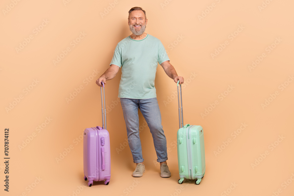 Full size photo of cheerful nice person have good mood hold suitcase isolated on beige color background Full size photo of cheerful nice person have good mood hold suitcase isolated on beige color background