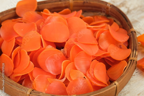 Raw crackers or kerupuk mentah in bamboo basket on white background photo