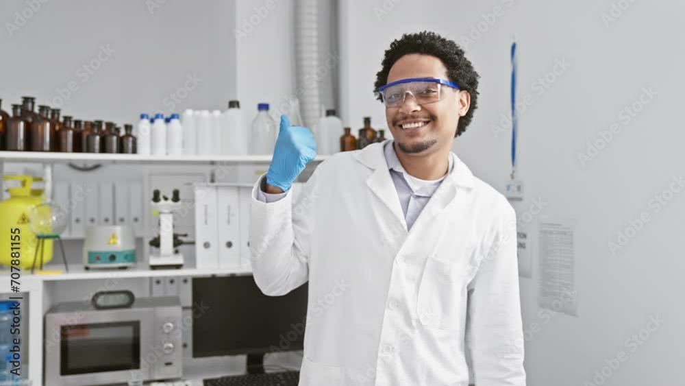 Cheerful young african american man scientist sporting safety glasses, flashing thumbs-up in the lab, his open mouth radiating joy and optimism! Cheerful young african american man scientist sporting safety glasses, flashing thumbs-up in the lab, his open mouth radiating joy and optimism!