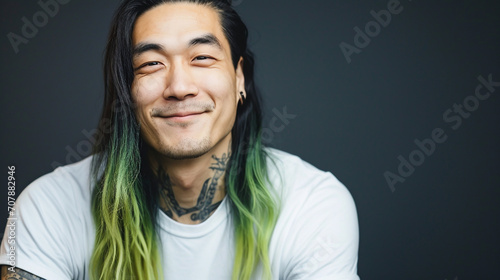 Smiling asian man with long dyed hairs.  photo