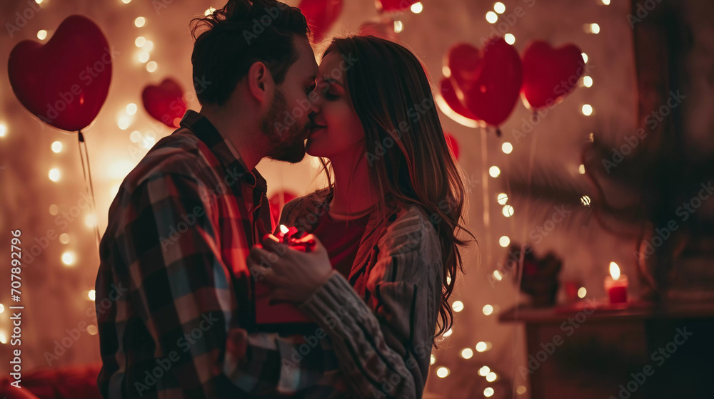 Man giving giftbox to women ,hugging, kissing and enjoy  for valentine's day with decorated heart balloon and blurred light