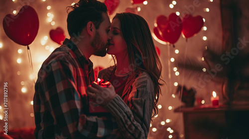 Man giving giftbox to women ,hugging, kissing and enjoy for valentine's day with decorated heart balloon and blurred light