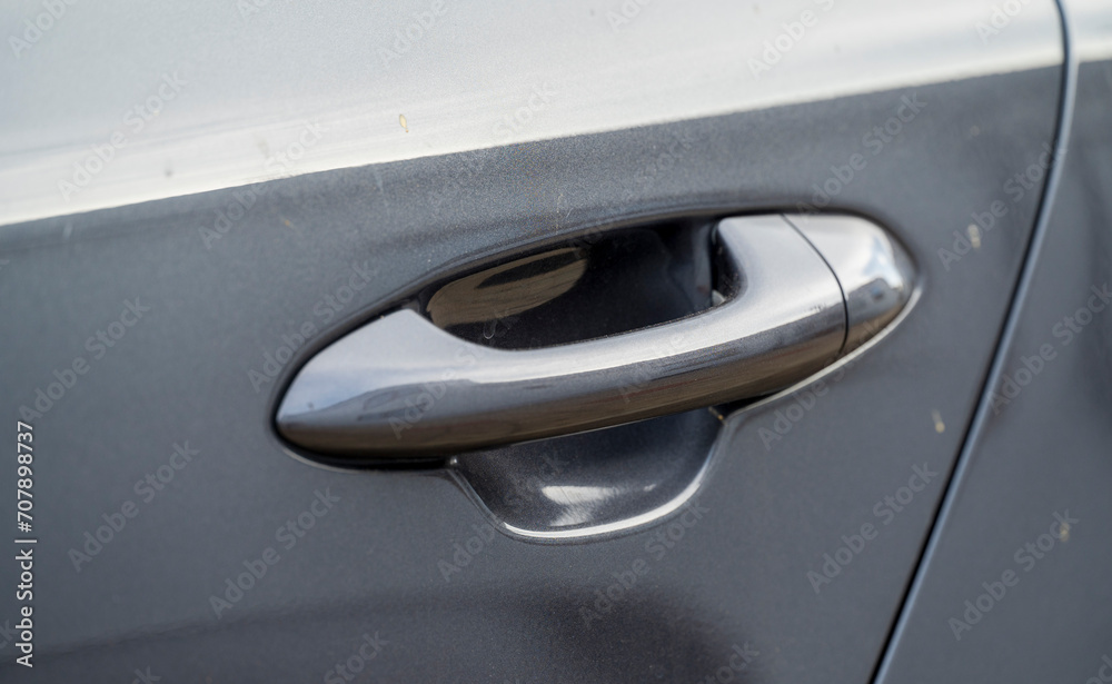 Detail of gray door handle on a car