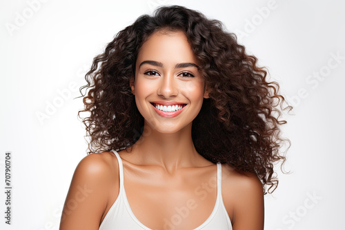 a closeup photo portrait of a beautiful young mexican model woman smiling with clean teeth. used for a dental ad. isolated on white background photo