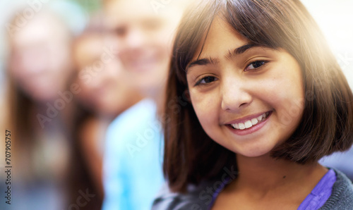 Girl, portrait and smile in corridor at school with confidence and pride for learning, education or knowledge. Student, person or face and happy in building or hallway before class and ready to study