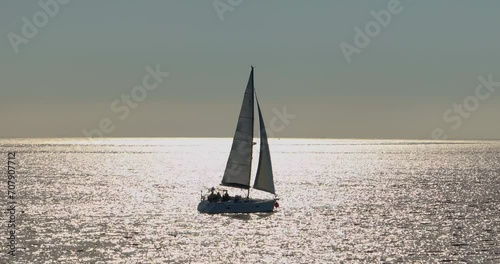 Aerial view Yacht sailing on opened sea. Yachting video. Yacht from above. Yachting at windy day photo