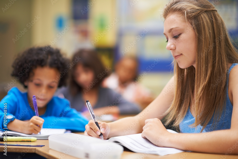 Girl, classroom and writing in book for education, learning and notes for knowledge in high school. Female person, notebook and pride for assessment or test, studying lesson and exam at academy Girl, classroom and writing in book for education, learning and notes for knowledge in high school. Female person, notebook and pride for assessment or test, studying lesson and exam at academy