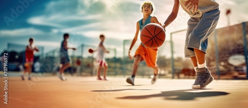 boys playing basketball outside © muza