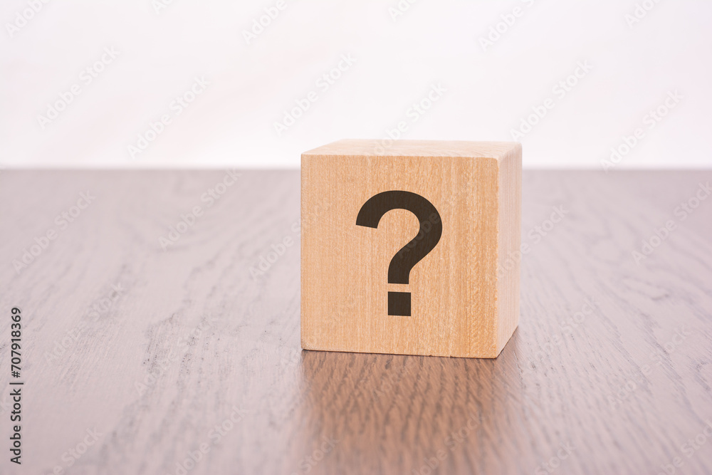 one wooden block with question mark over a grey background with copy space one wooden block with question mark over a grey background with copy space