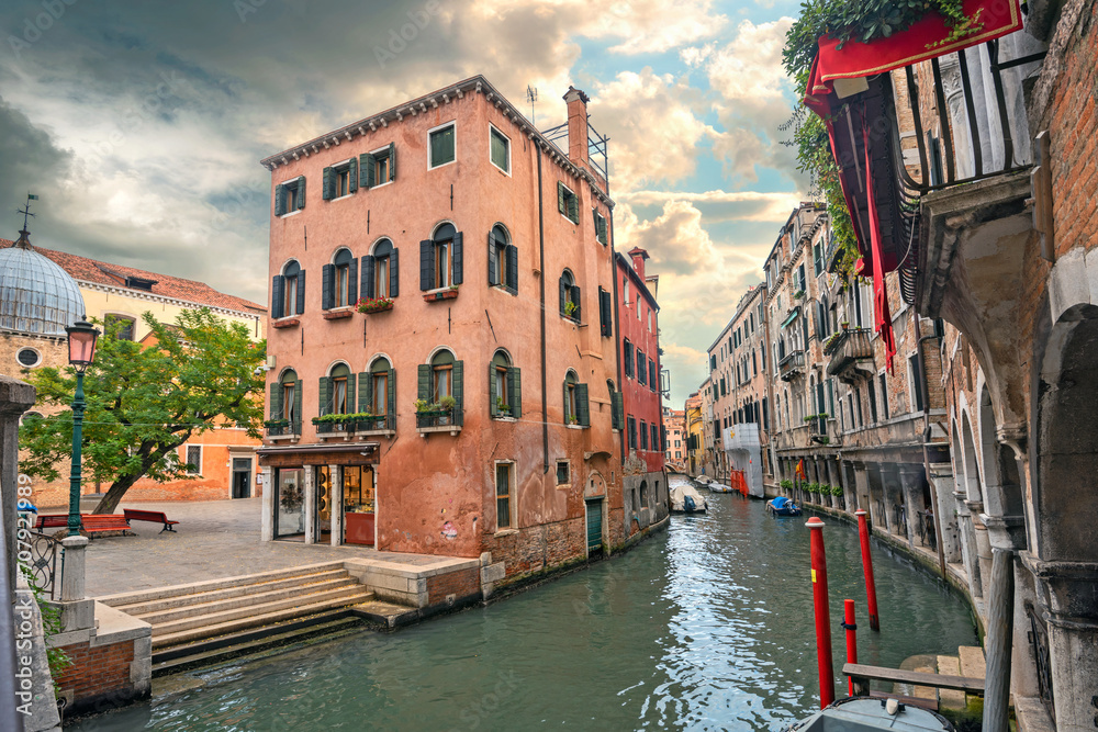 View of historic buildings on narrow canal in Venice. Italy