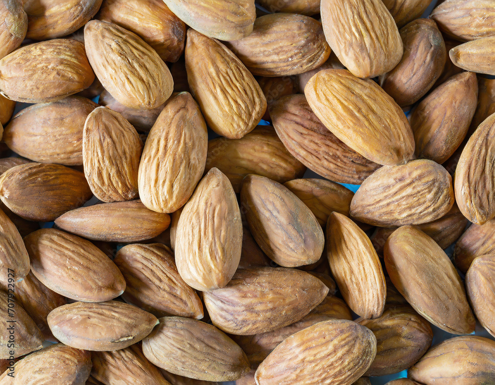 Fototapeta premium A pile of almonds. Closeup of almonds. 