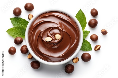 Top view of a collage design with chocolate paste, hazelnuts, and a white background.