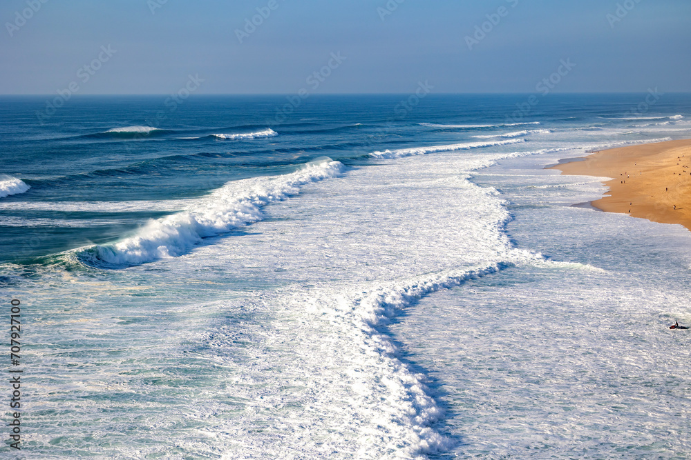 Obraz premium Sandy beach, panorama. Panoramic view of the sandy beach. The sea wave rolls on the shore.