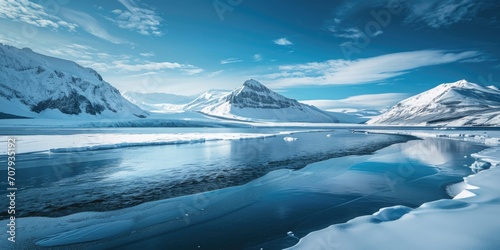 A tranquil scene of snow-covered mountains reflected in a peaceful body of water. Perfect for nature and landscape enthusiasts