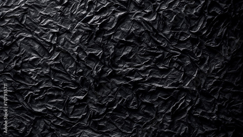 Black abstract background with crumpled black paper. 