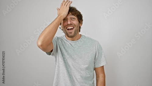 Oops! frustrated young man in t-shirt smacks forehead with hand, realizing stupid mistake. forgetful, handsome guy remembers error with annoyed regret. isolated on white background. photo