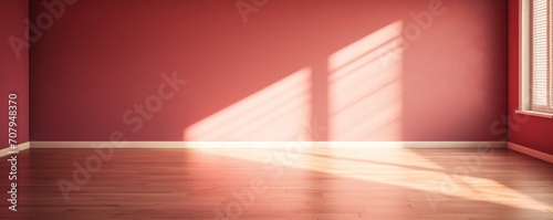 Light ruby wall and wooden parquet floor  sunrays and shadows from window