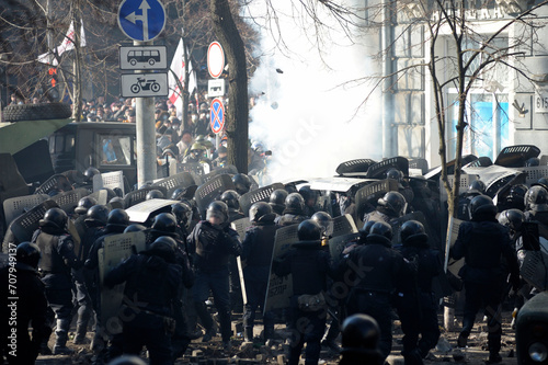 Policemen Berkut unit attacking protesters on Institutskaya street. Revolution of Dignity, the first street clashes. Kyiv, Ukraine photo