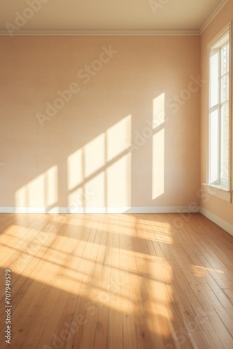 Light tan wall and wooden parquet floor, sunrays and shadows from window