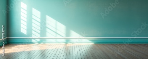 Light turquoise wall and wooden parquet floor, sunrays and shadows from window 