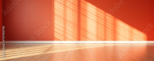 Light vermilion wall and wooden parquet floor, sunrays and shadows from window 