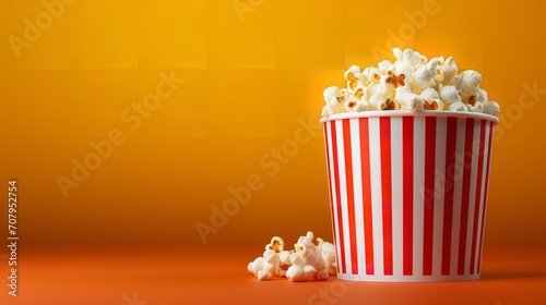 Popcorn in a striped box with a yellow backdrop and empty space, top view, flavors, Generative AI.