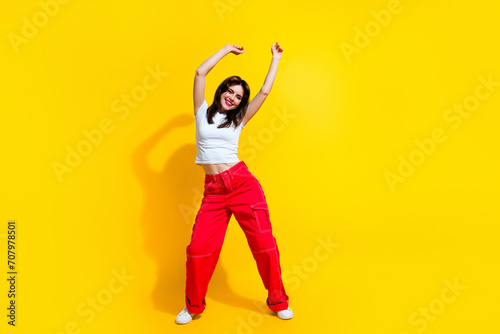 Full length photo of adorable dreamy woman dressed white t-shirt enjoying discotheque empty space isolated yellow color background