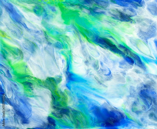Bright colorful acrylic texture. Liquid flowing acrylic on canvas. Marble texture in rainbow colors. Hand made abstract artwork with white, blue, green and yellow colors.