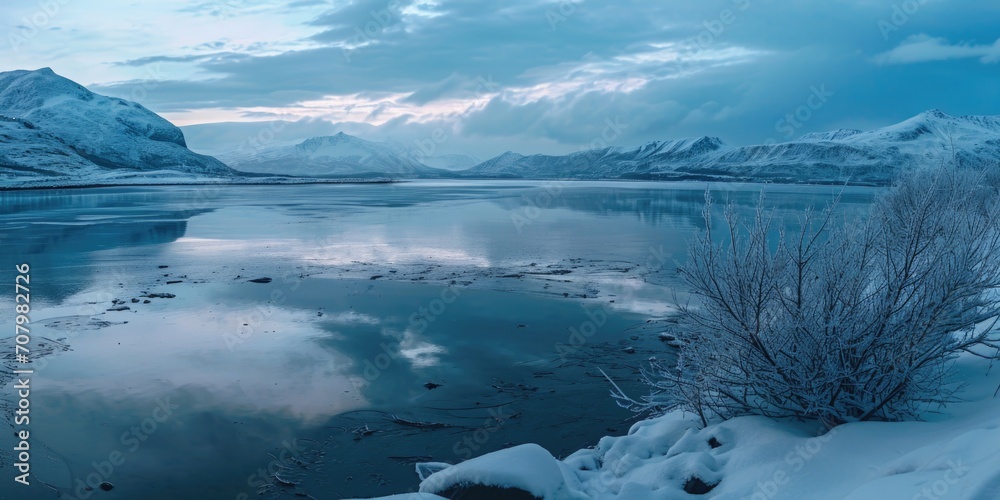 A stunning image of snow covered mountains surrounding a serene body of water. Perfect for travel blogs, nature websites, or winter-themed designs A stunning image of snow covered mountains surrounding a serene body of water. Perfect for travel blogs, nature websites, or winter-themed designs