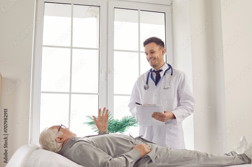 Senior man patient engaging in a medical consultation at the hospital office, receiving attentive care and valuable healthcare advice from a professional smiling doctor or nurse during visit. Senior man patient engaging in a medical consultation at the hospital office, receiving attentive care and valuable healthcare advice from a professional smiling doctor or nurse during visit.