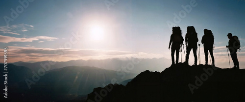 sunrise over the mountains with backpackers and adventurers silhouette. Concept of adventure.