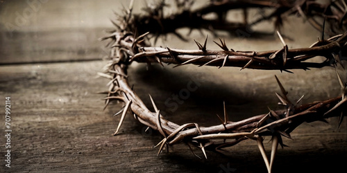 Crown of thorns on a wooden table dark background. photo