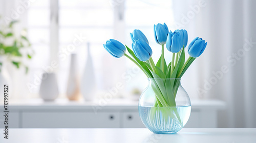 Blue tulips in a glass vase #707997527