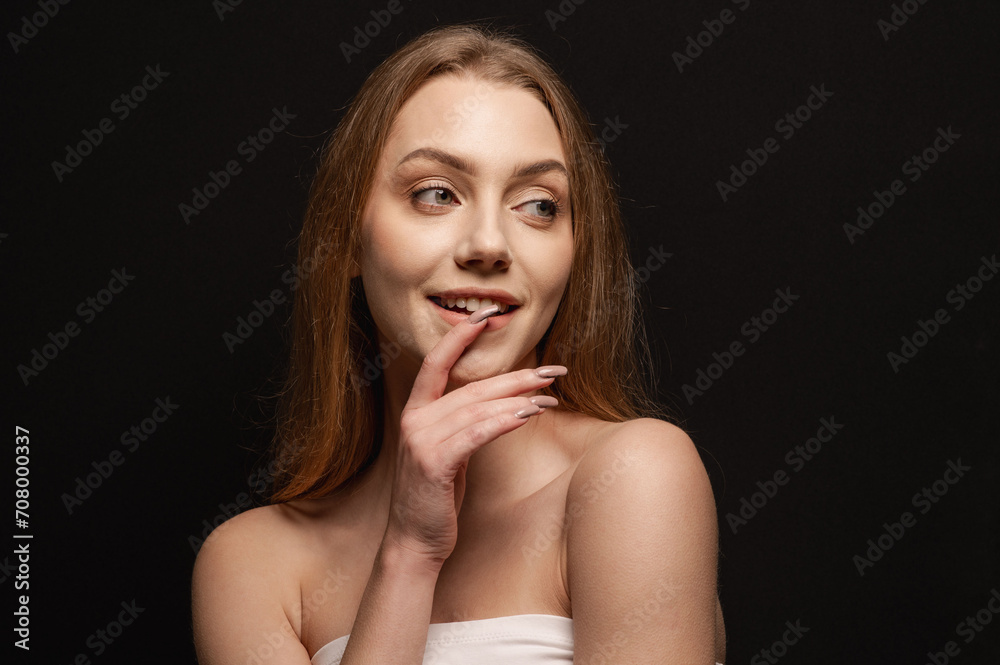 Beauty portrait of a beautiful blonde girl on an isolated black background. Skin care Beauty portrait of a beautiful blonde girl on an isolated black background. Skin care